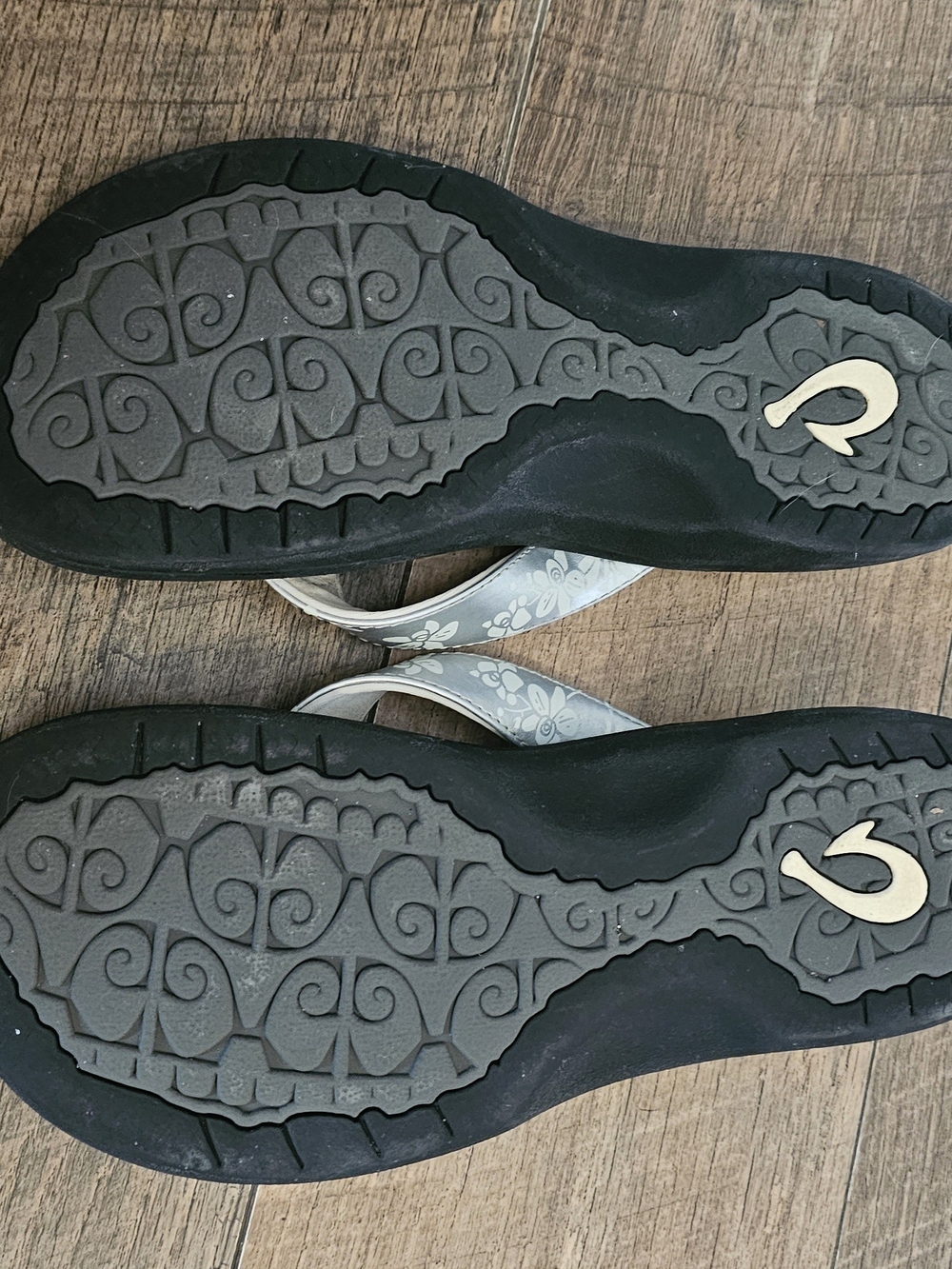 OluKai Women's Floral Strap Flip Flops - Black Soles, Silver Gray/White Straps - Picture 2 of 3